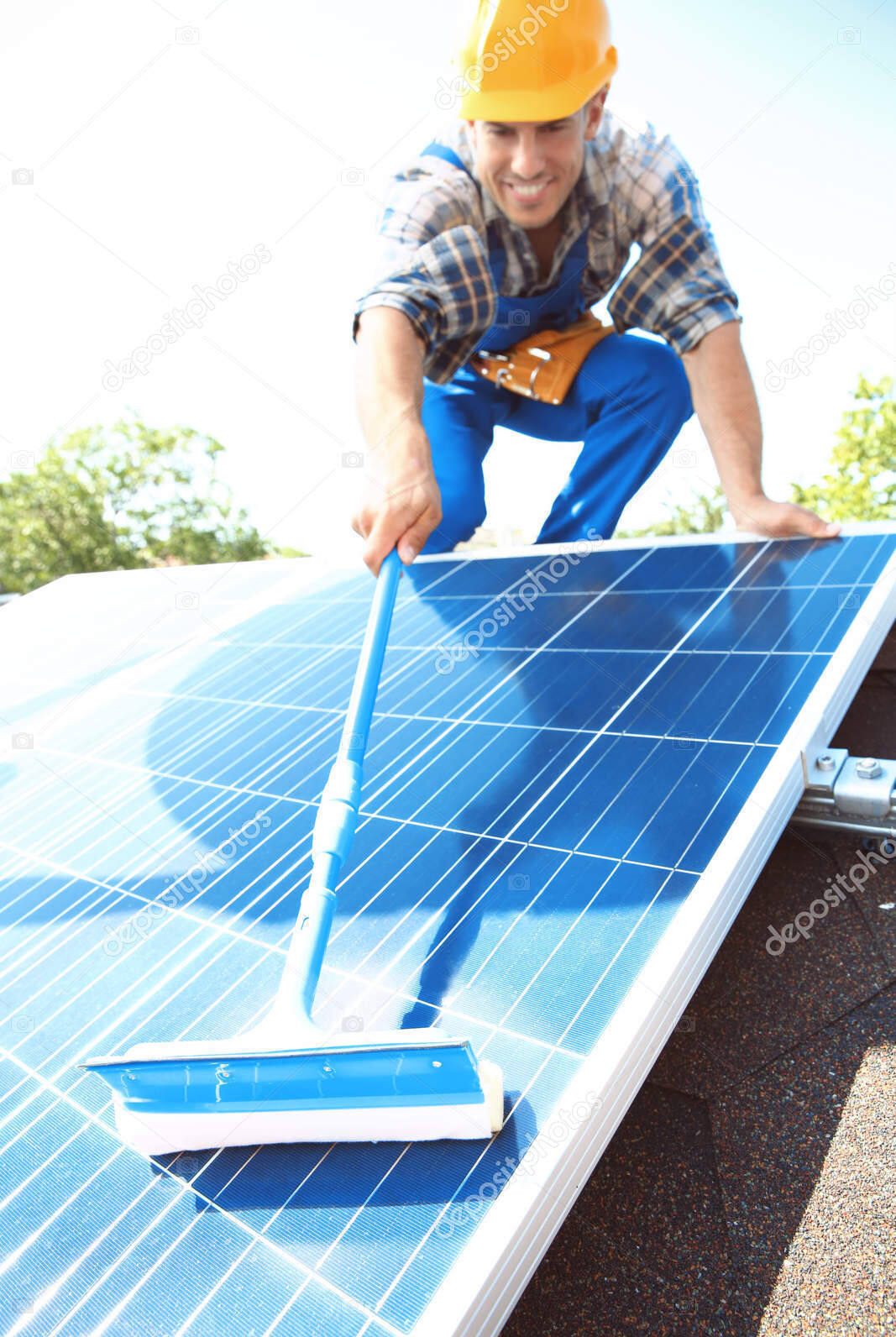 worker cleaning solar panels after installation outdoors